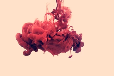 A Splash Of Red Paint In Water
