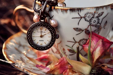 Old Clock Hanging From Cup