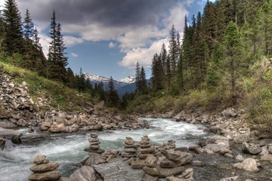 Stone Cairns Along A Beautiful Mountain Stream   (