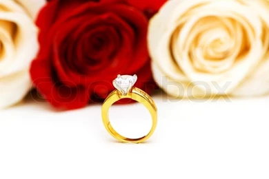 Engagement Ring And Roses At The Backgrounds